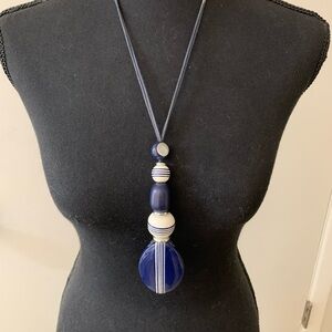 Chicos blue and white ceramic and wood pendant necklace. Read